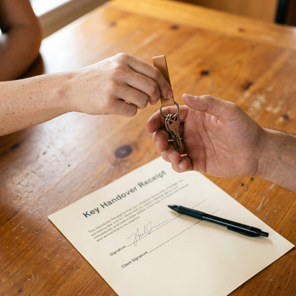 House keys being handed over with a signed receipt