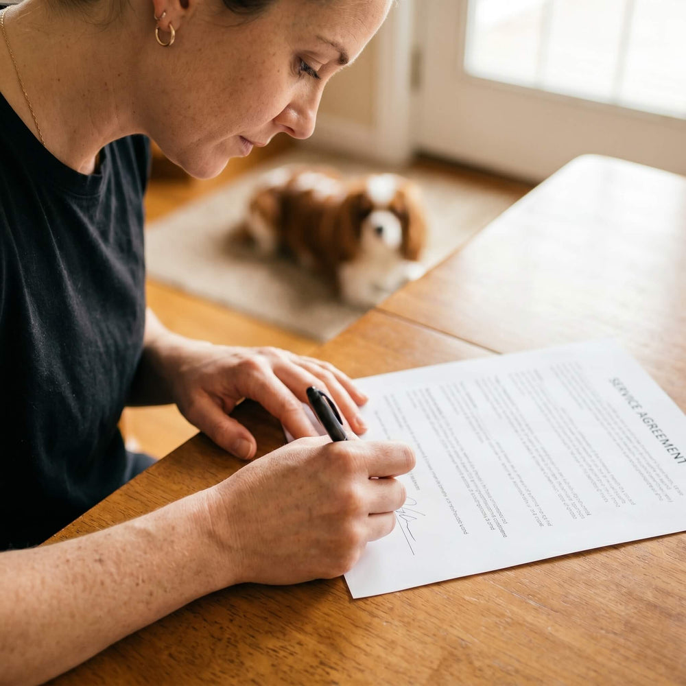 Hand signing a service agreement